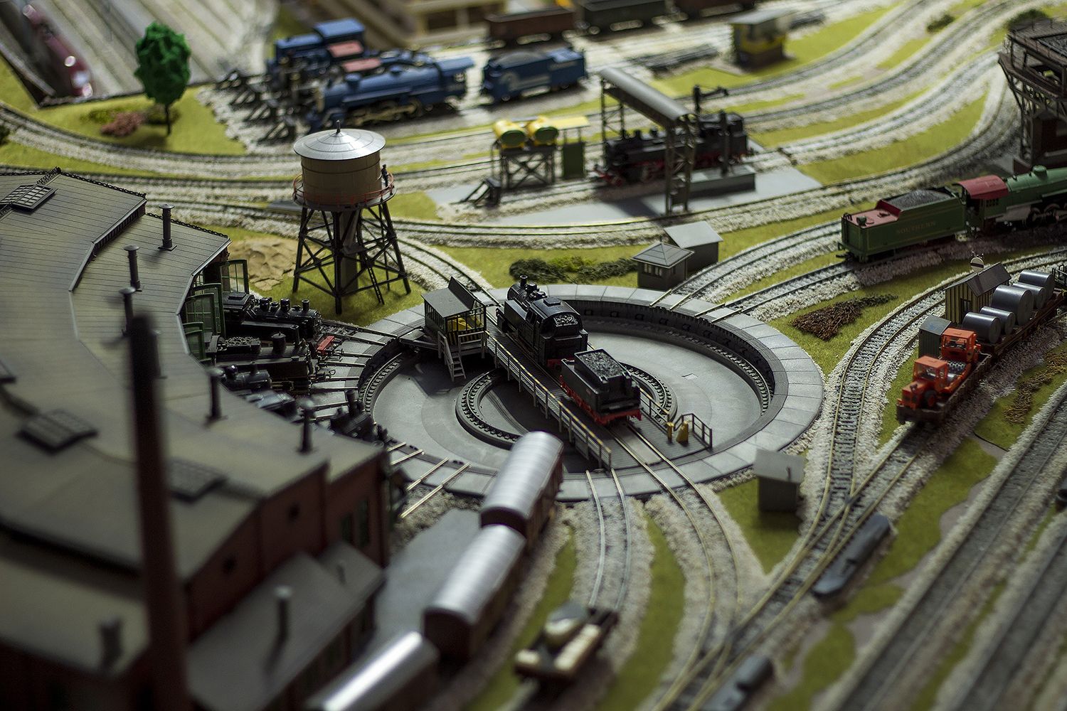 A model railroad in a popular layout with a turntable and model trains