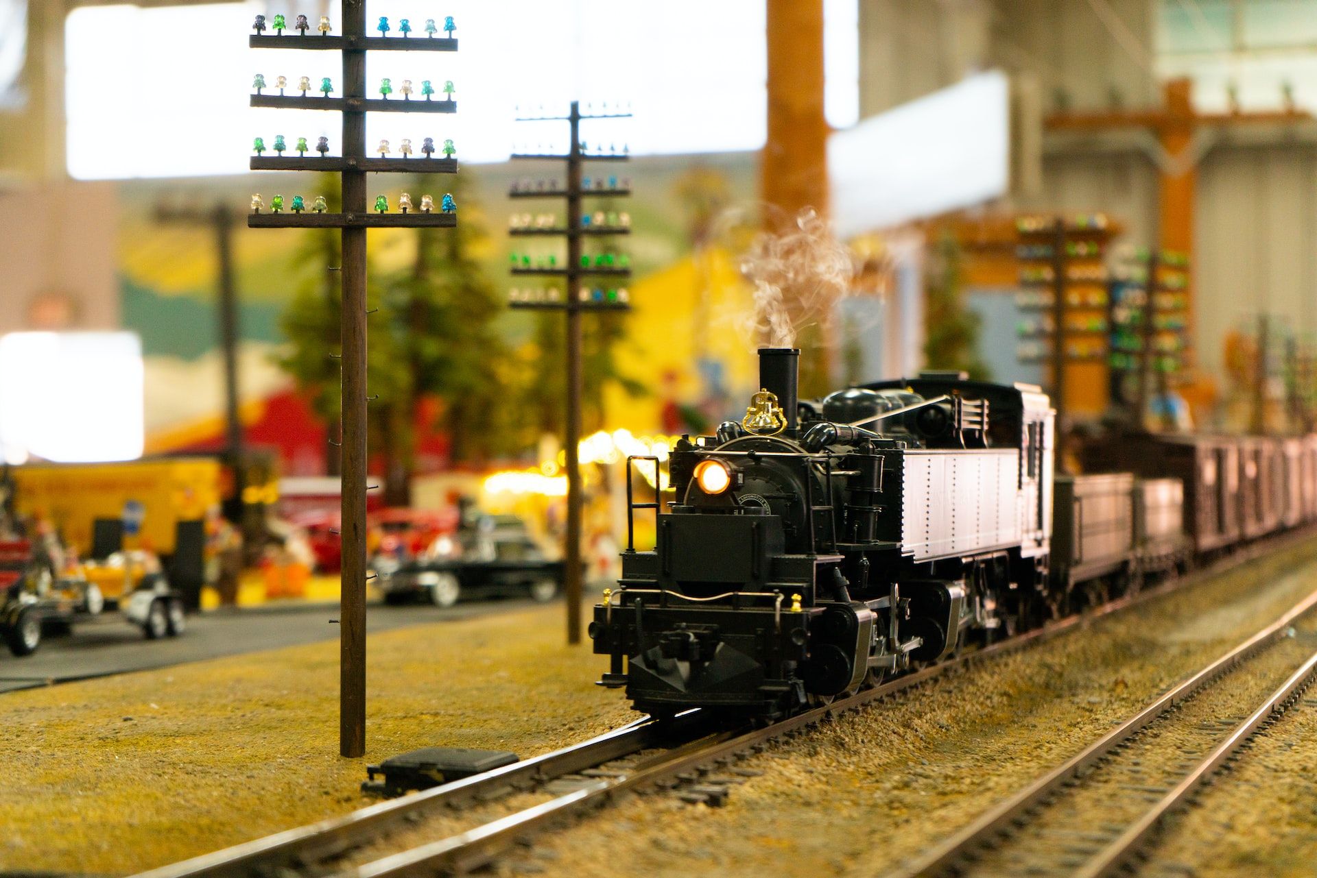 A model steam locomotive on an O gauge track layout