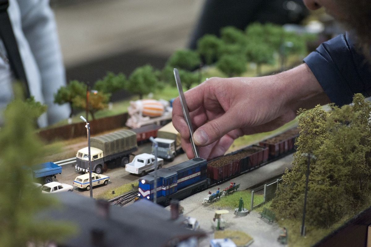 A model railway engineer setting up a Hornby train set