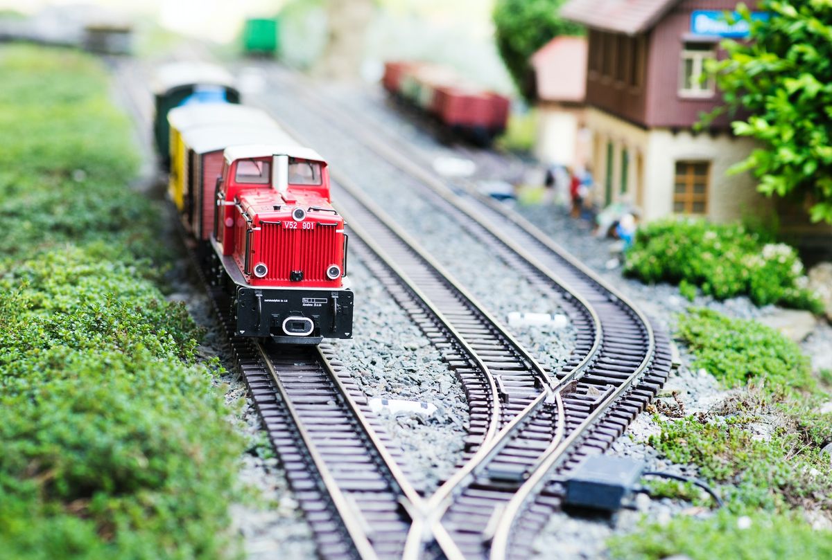 An electric DCC train set operating on a model railway layout